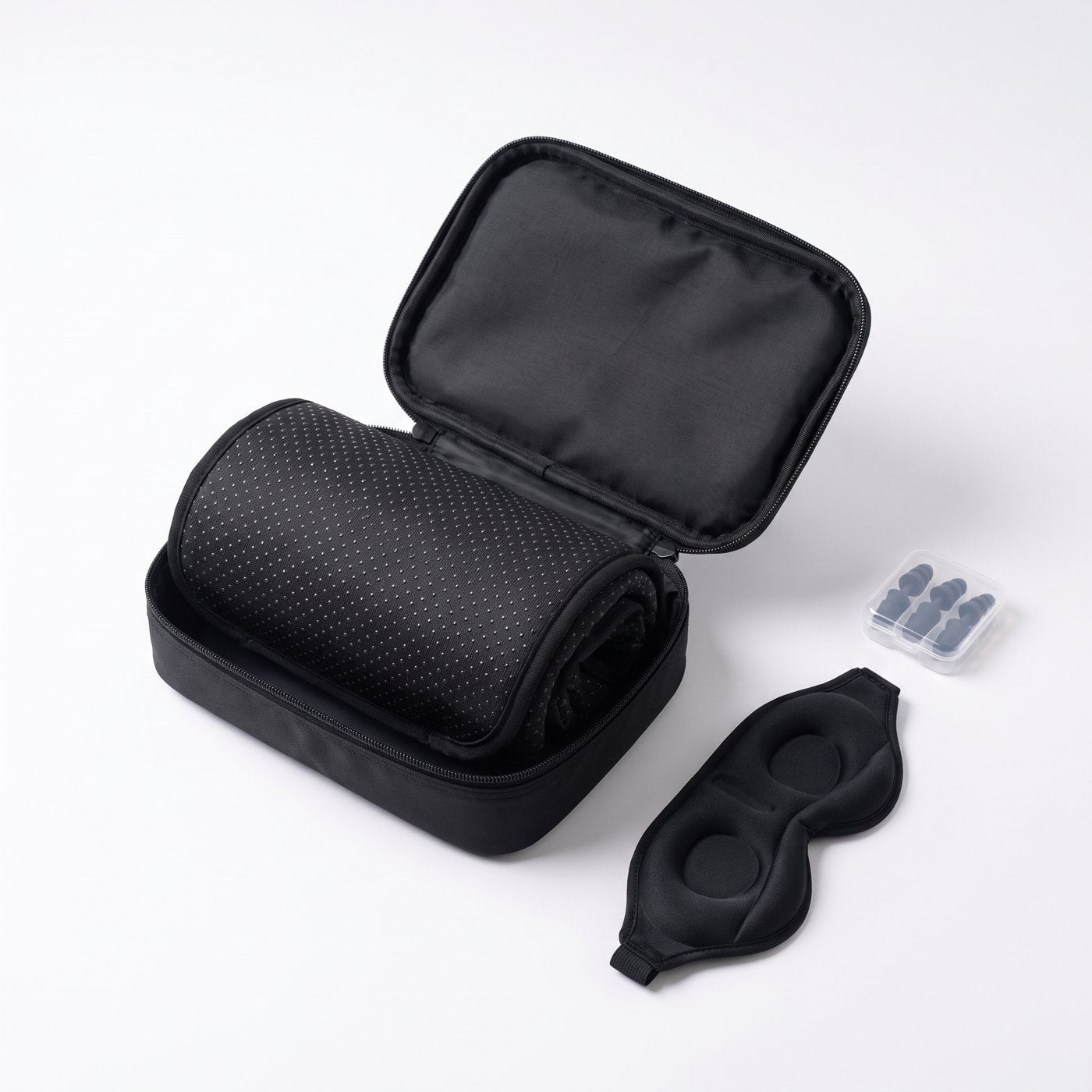 Rolled cushion, eye mask and earplugs in the zip travel case